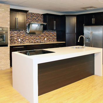 Espresso shaker RTA cabinetry in a modern kitchen with marble countertops