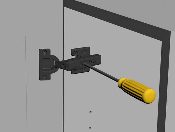 Screwing in adjustable screws to the center of hinges on an RTA White Shaker Wall Cabinet