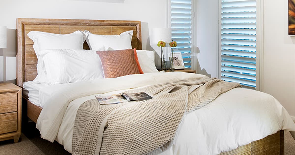 Bedroom with white timber plantation shutters.