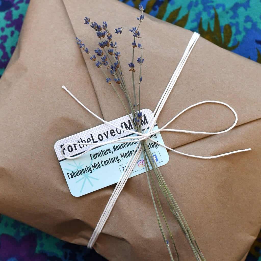 sustainable brown Kraft paper package tied with cotton string bow with dried lavender showing For the Love Of MCM Vintage business card