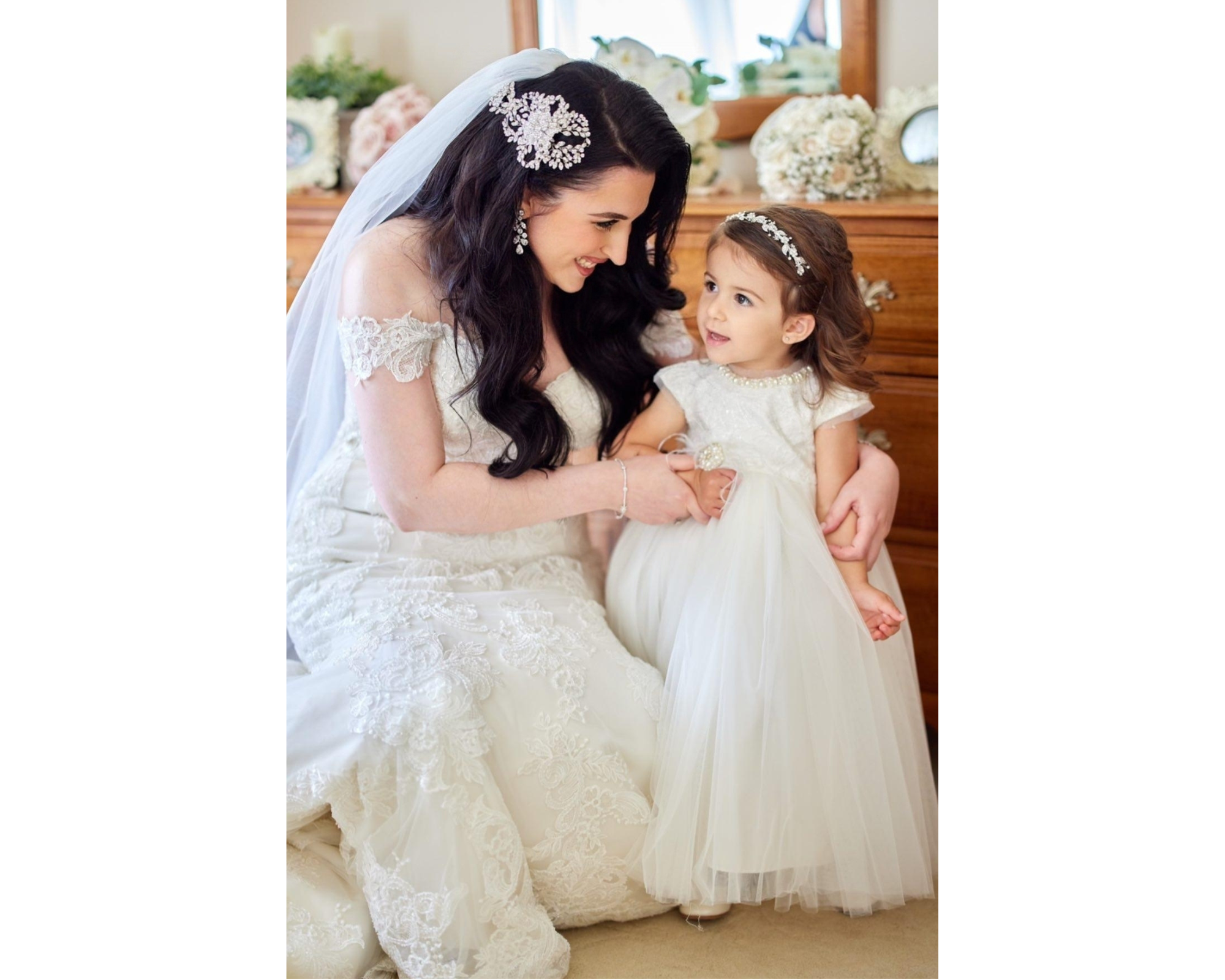 Our elegant Bridal Styles bride with her adorable flowergirl. The bride is wearing her bold Swarovski crystal hairvine, veil, and wedding gown.