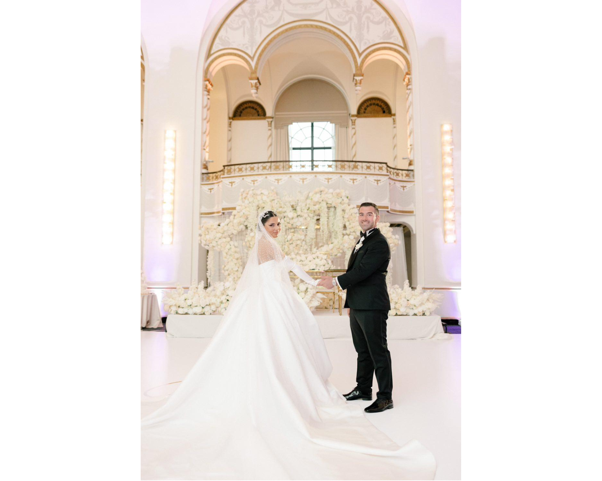 Valentina with her new hubby surrounded at their fairytale wedding! She's wearing her Swarovski crystal headpiece, gloves, ballgown, and cathedral veil. 