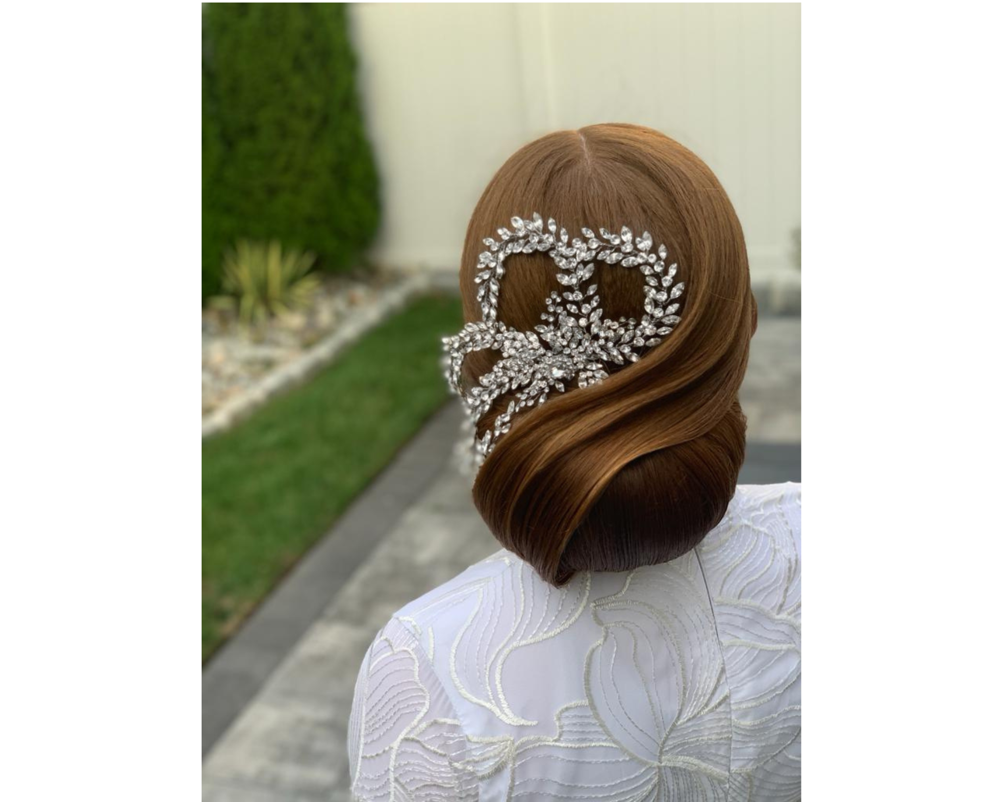 A gorgeous, low bridal bun with waves and a statement Swarovski crystal hair comb.