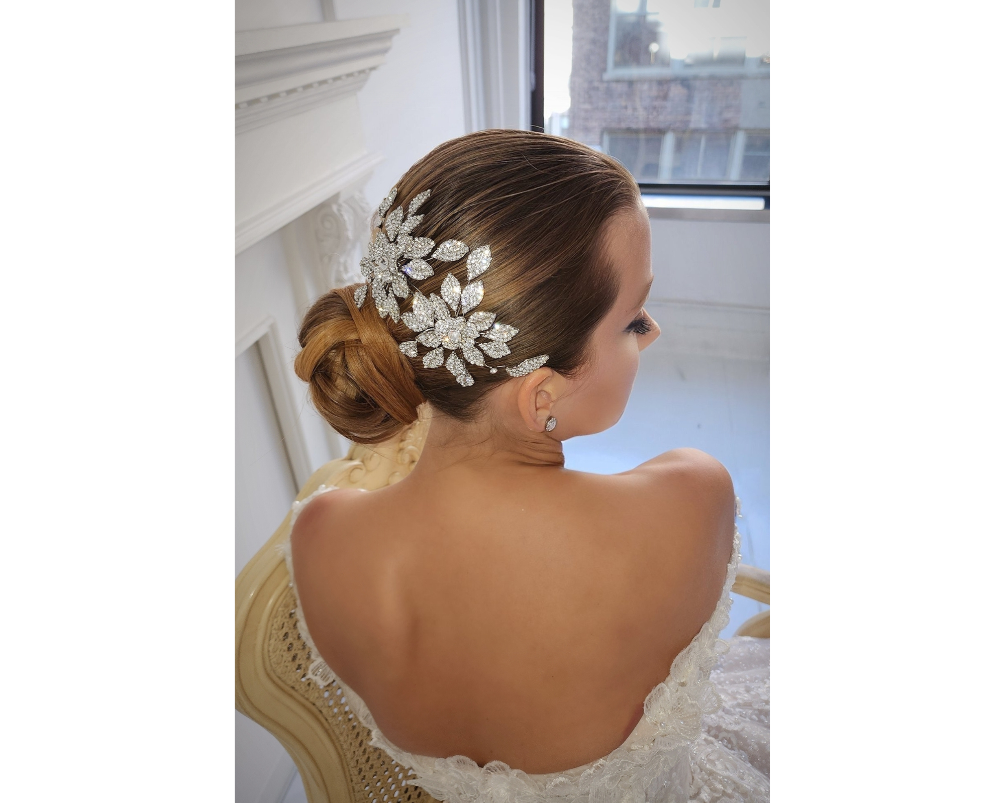 A gorgeous, low bridal bun and a statement double blossom flower Swarovski crystal hair comb.