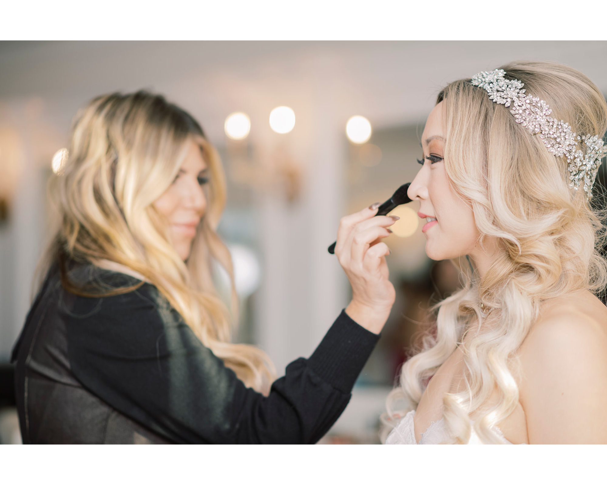 Lovely real bride Yvonne getting her makeup done on her big day. Her blonde hair is down and she’s wearing a sparkling halo bridal headpiece.