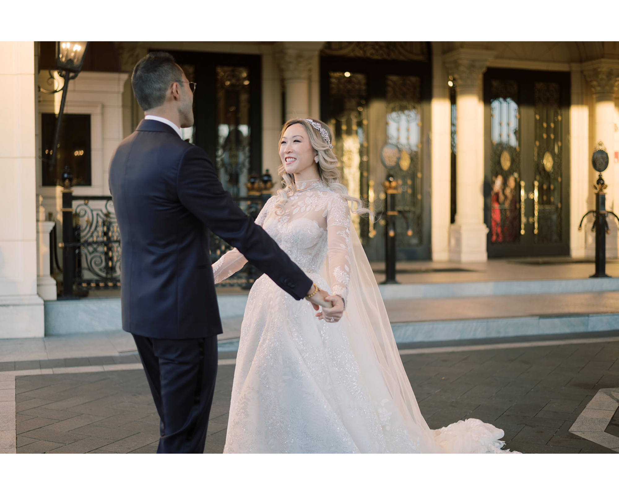 Yvonne smiling as she sees her groom for the first time!  Her blonde hair is in soft waves and she’s wearing a sparkling halo bridal headpiece.