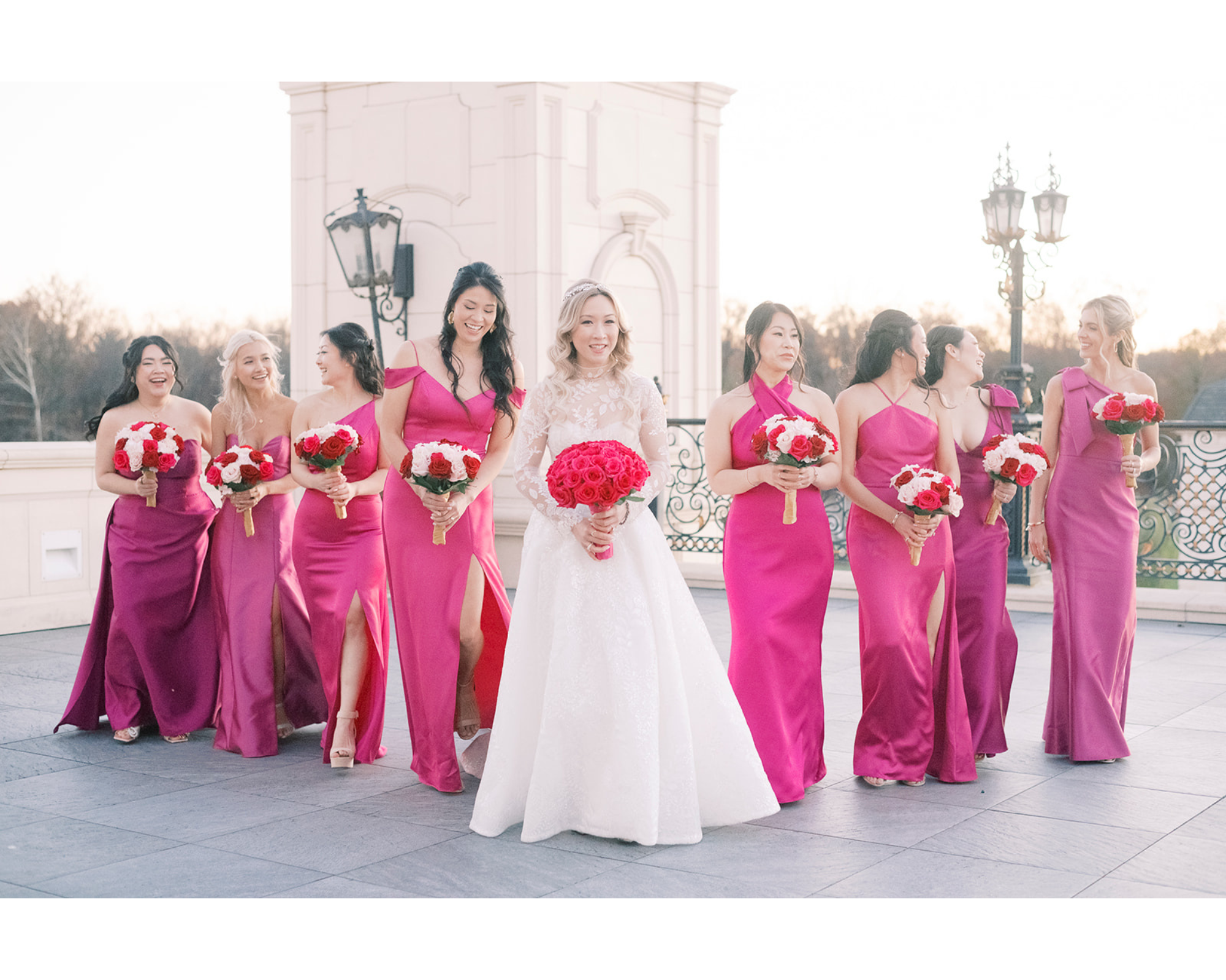 Yvonne in her magenta second wedding dress with her bridesmaids wearing complimentary pink dresses.