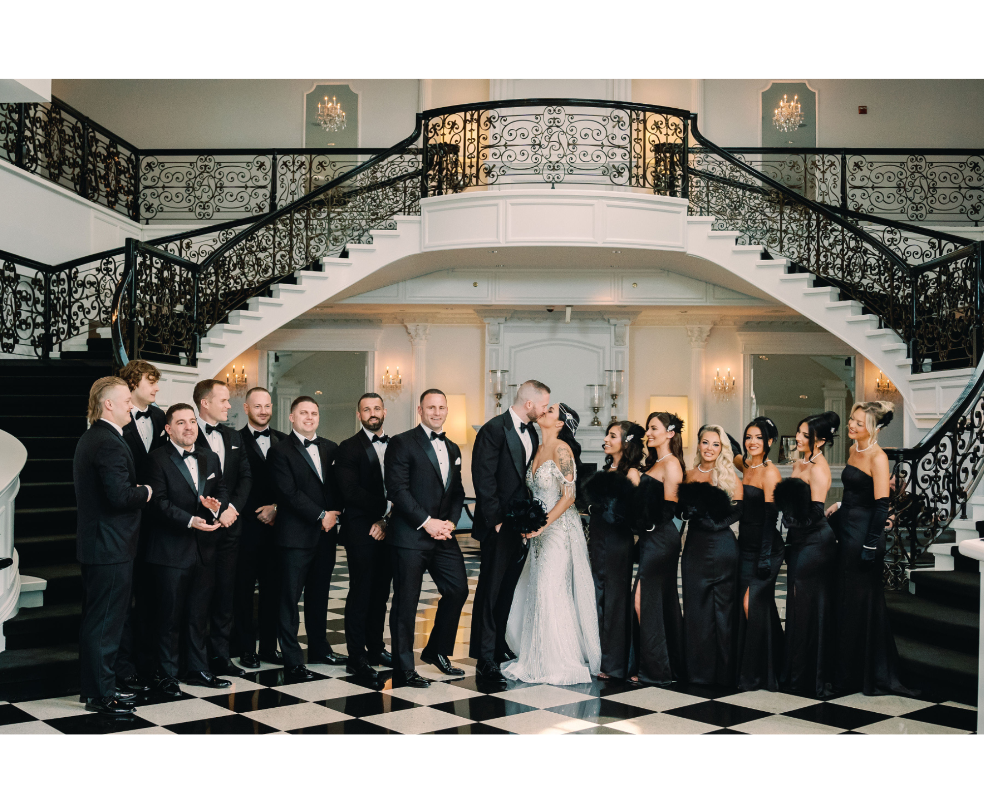 Great Gastby-inspired wedding party with black and white attire and feathers.