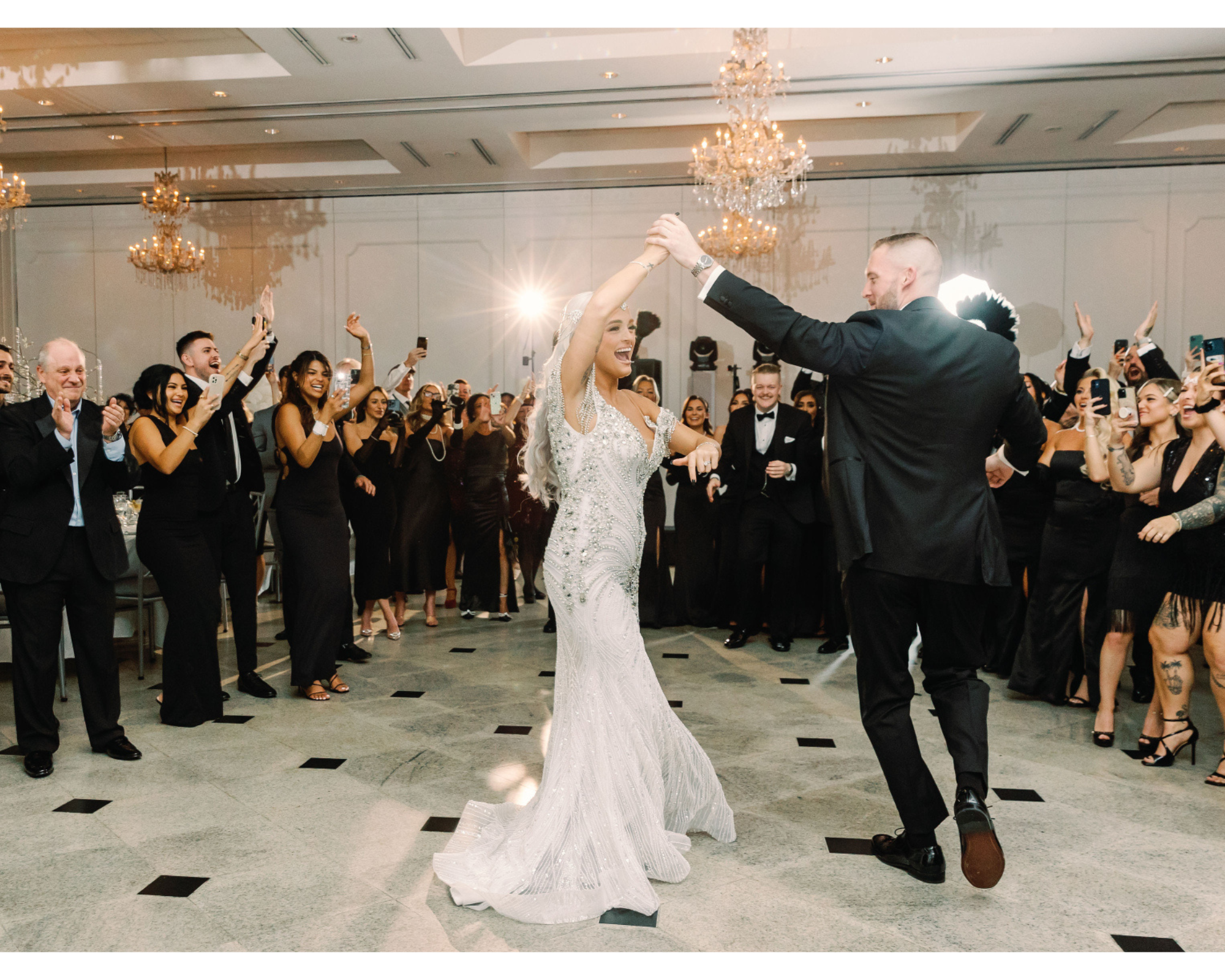 Great Gatsby-inspired bride dancing with her handsome groom. She's wearing a Swarovski-crystal bridal halo headpiece and beaded gown.