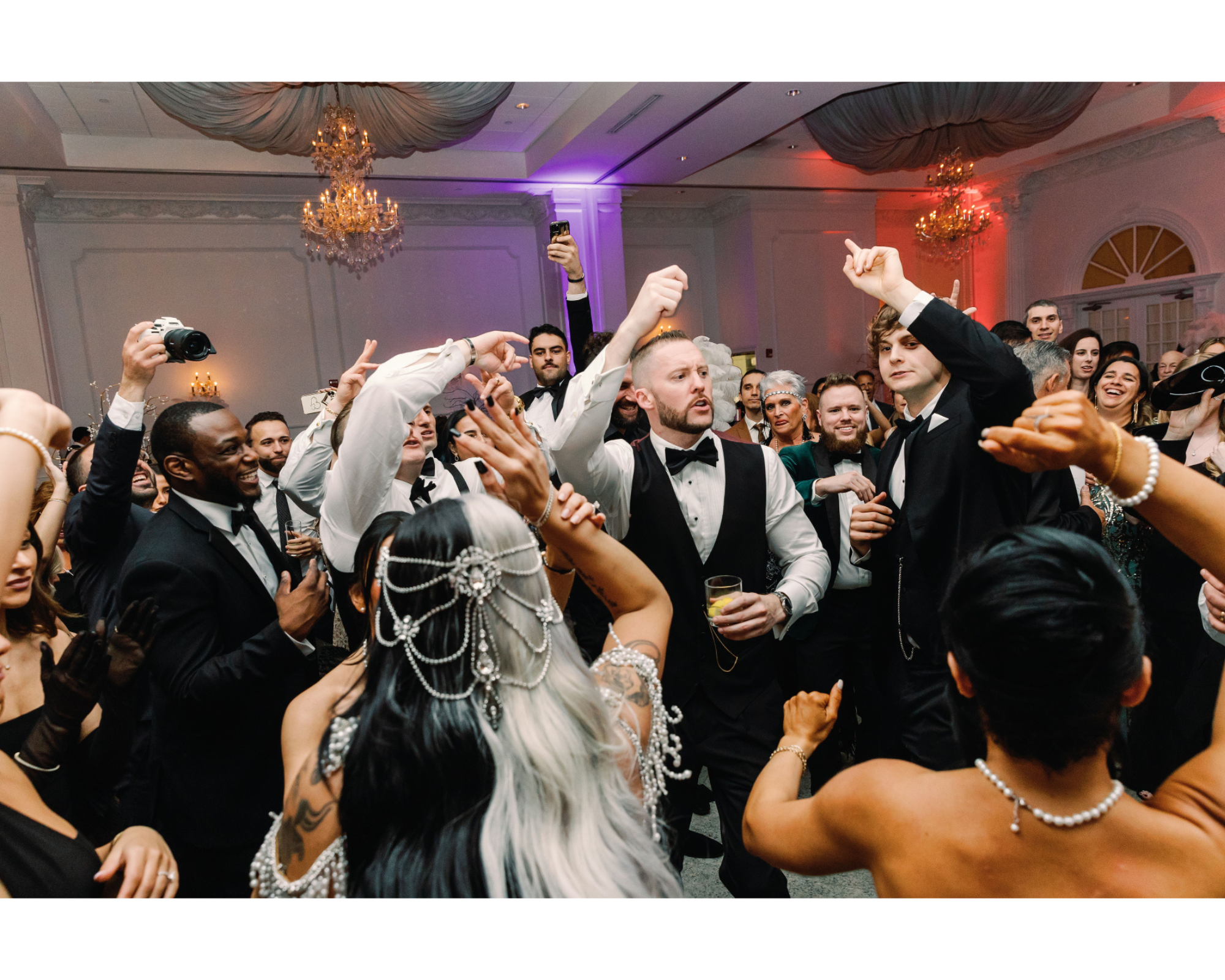 Great Gatsby-inspired bride dancing with her handsome groom. She's wearing a Swarovski-crystal bridal halo headpiece and beaded gown.