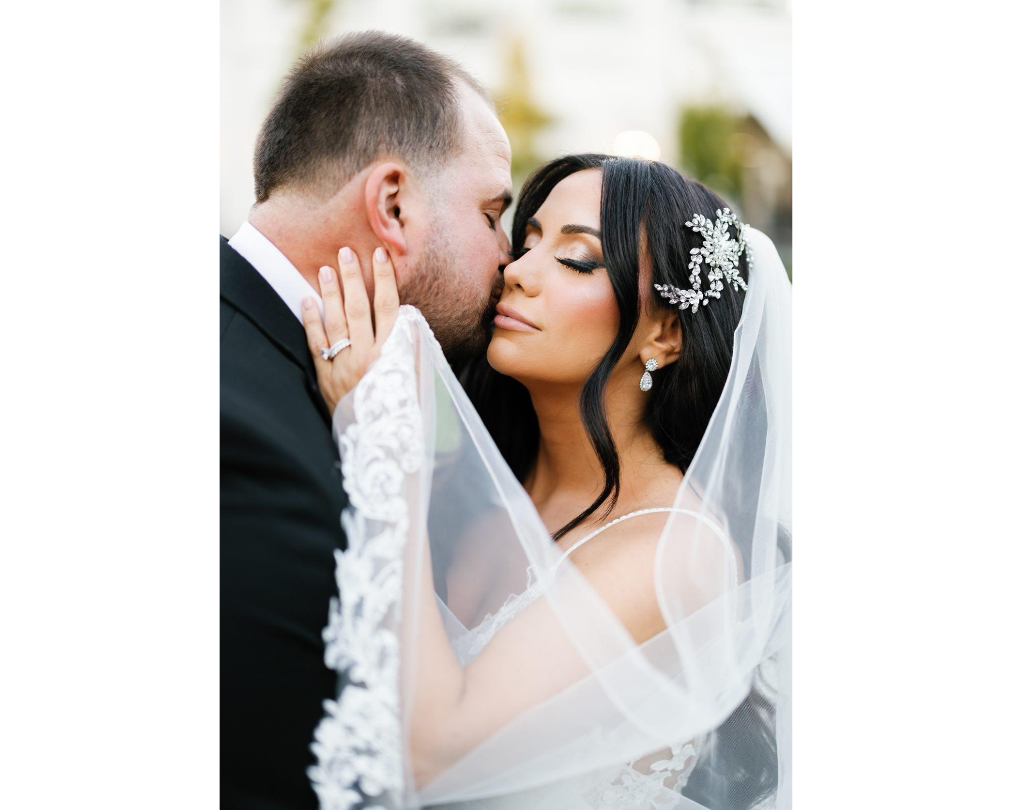 Our beautiful bride and her handsome groom! The bride is wearing a crystal bridal comb and a lace-edged veil.