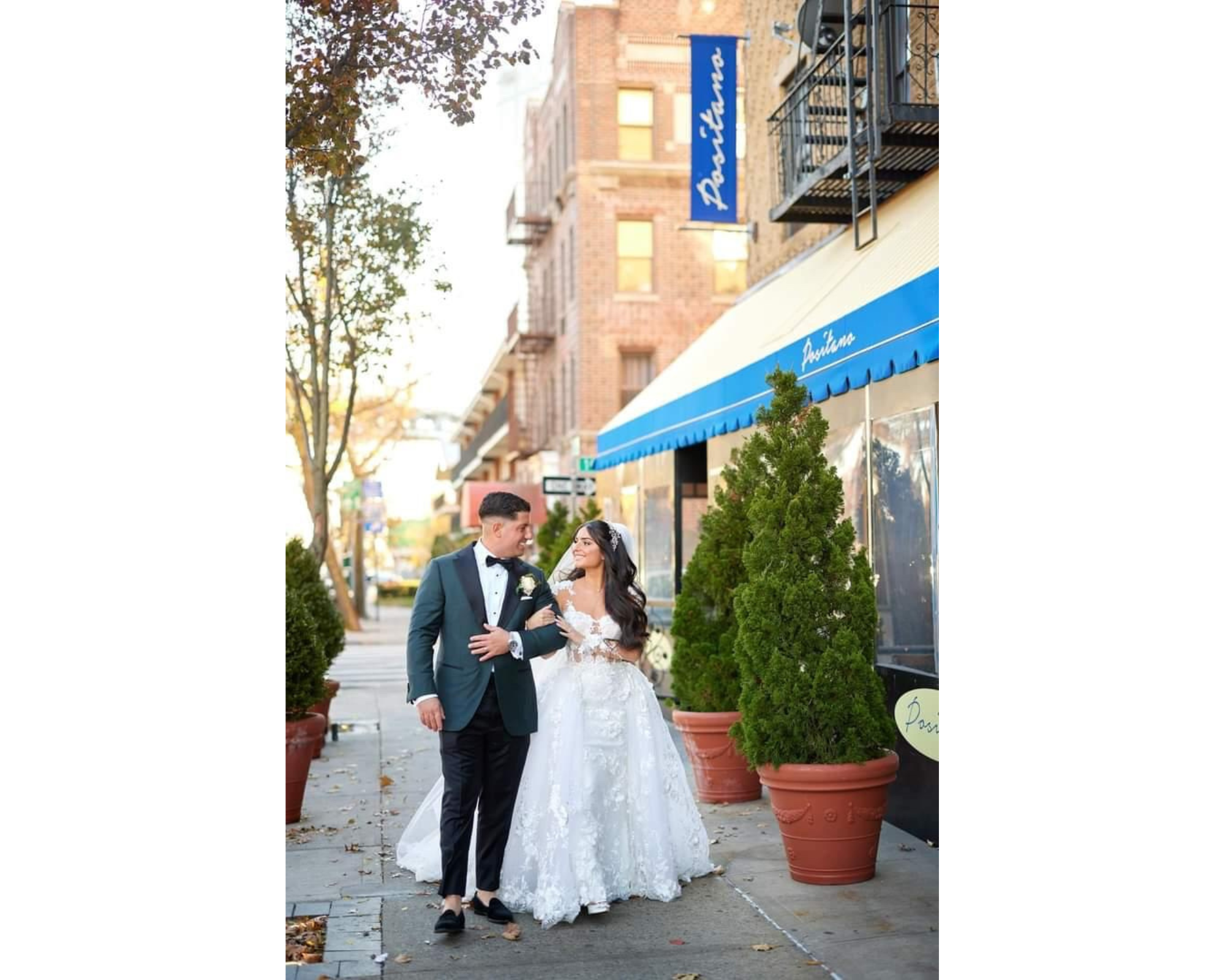 Beautiful Amanda  in her wedding gown arm in arm with handsome groom walking down a NYC street