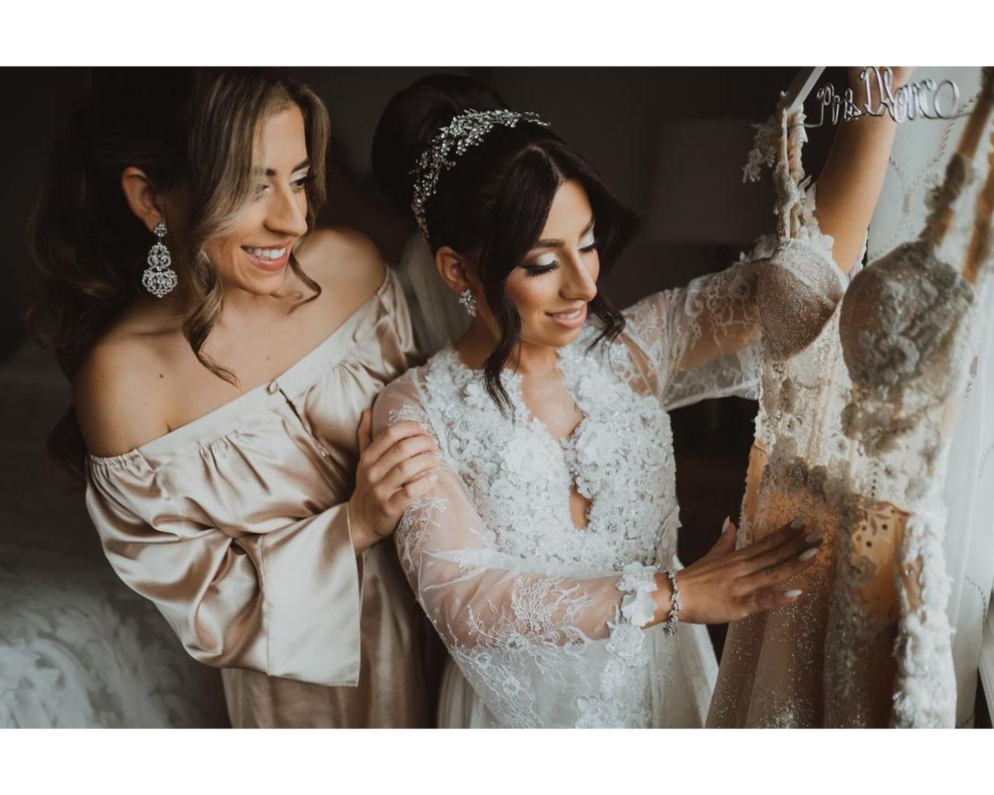 Our beautiful bride getting ready in her Lé Laurier robe, Swarovski crystal bridal headpiece, embroidered cathedral veil, and earrings.