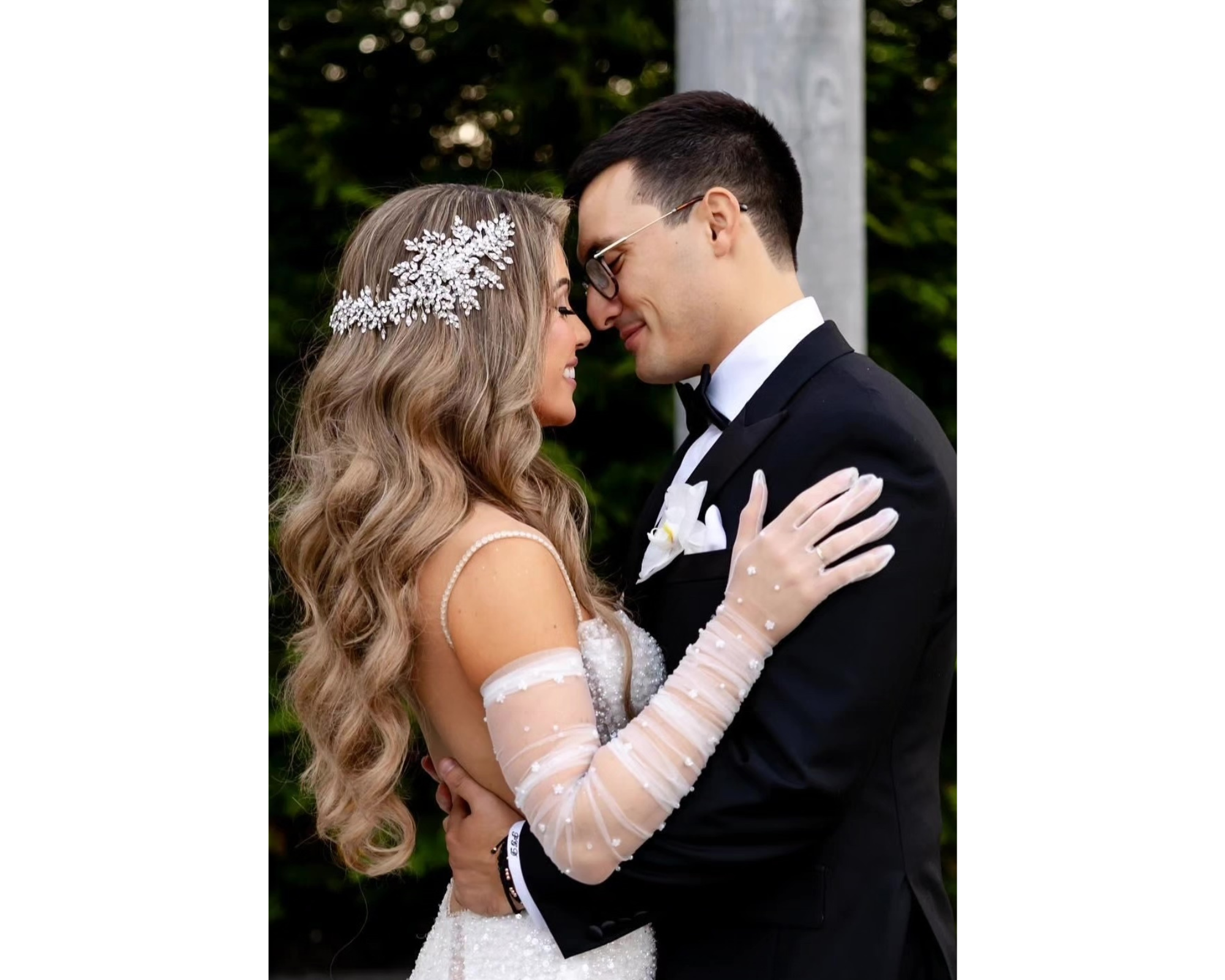 Our beautiful bride with her new husband! Ioanna is wearing a Swarovski crystal bridal hair vine, sheer gloves, and her stunning wedding dress.