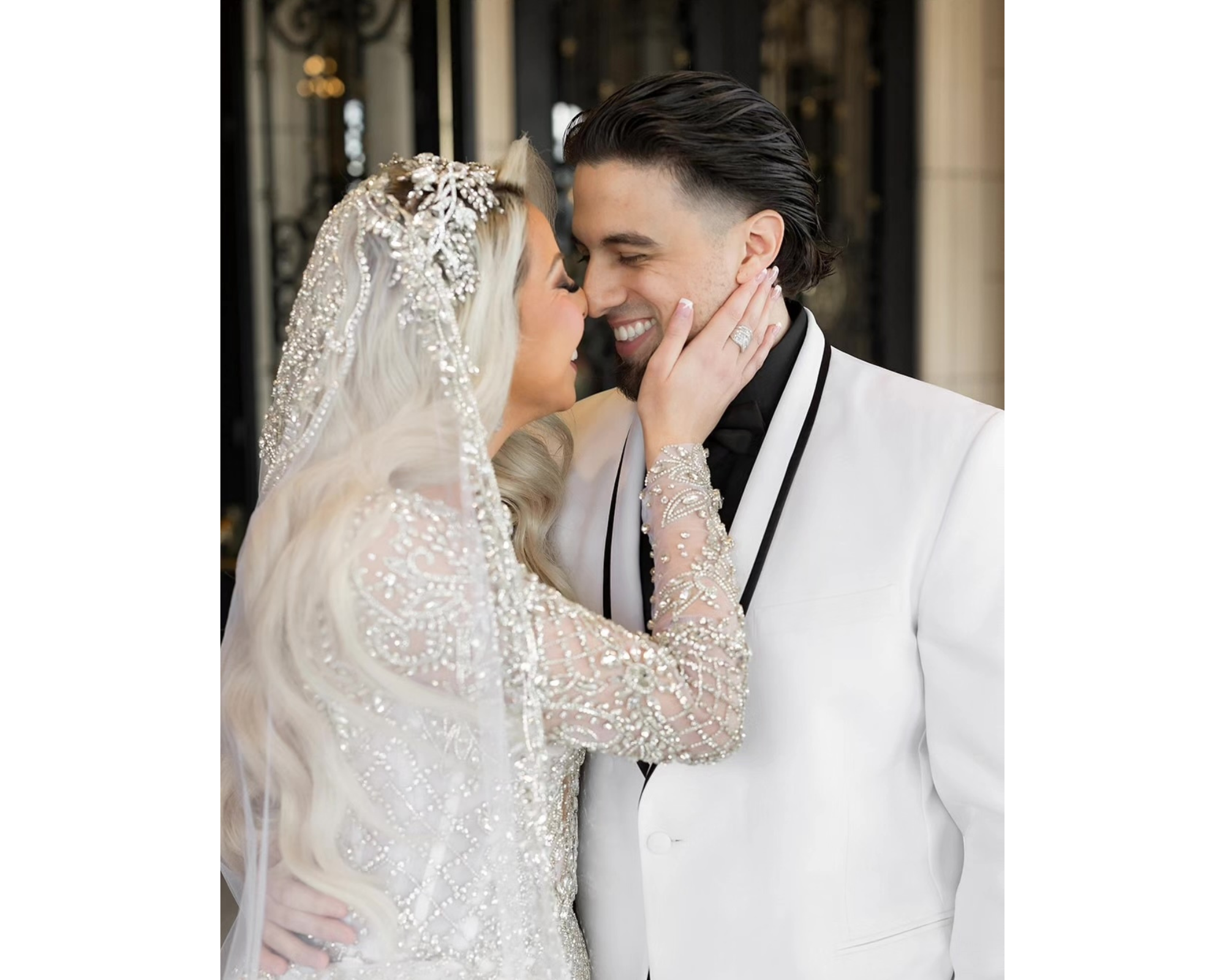 Sabrina and her groom kissing. She's wearing a beaded dress and Swarovski crystal bridal headband. He is in a black and white tux.