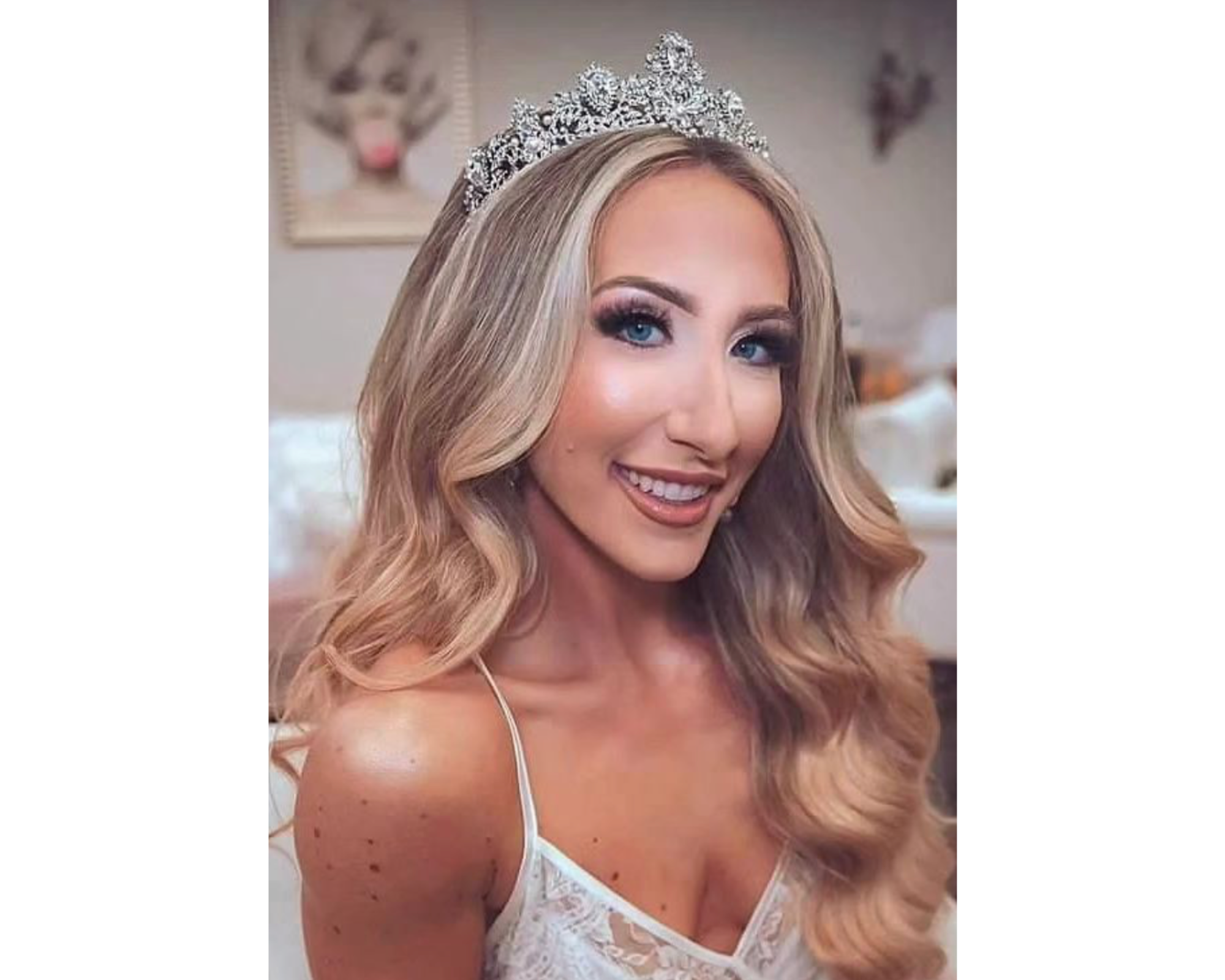A lovely bride with her blond hair in soft waves wearing a Swarovski crystal wedding tiara.