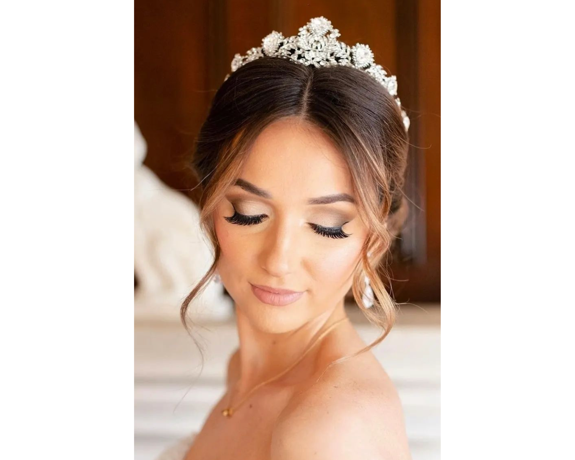 A lovely bride with her hair up wearing a dazzling Swarovski crystal wedding tiara.