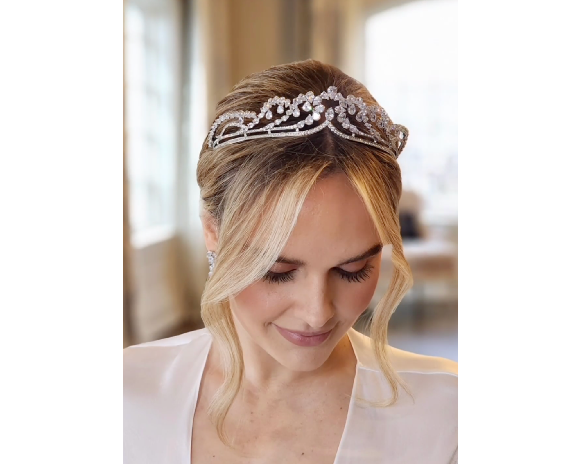 A beautiful bride with her hair up  wearing a delicate Swarovski crystal tiara.