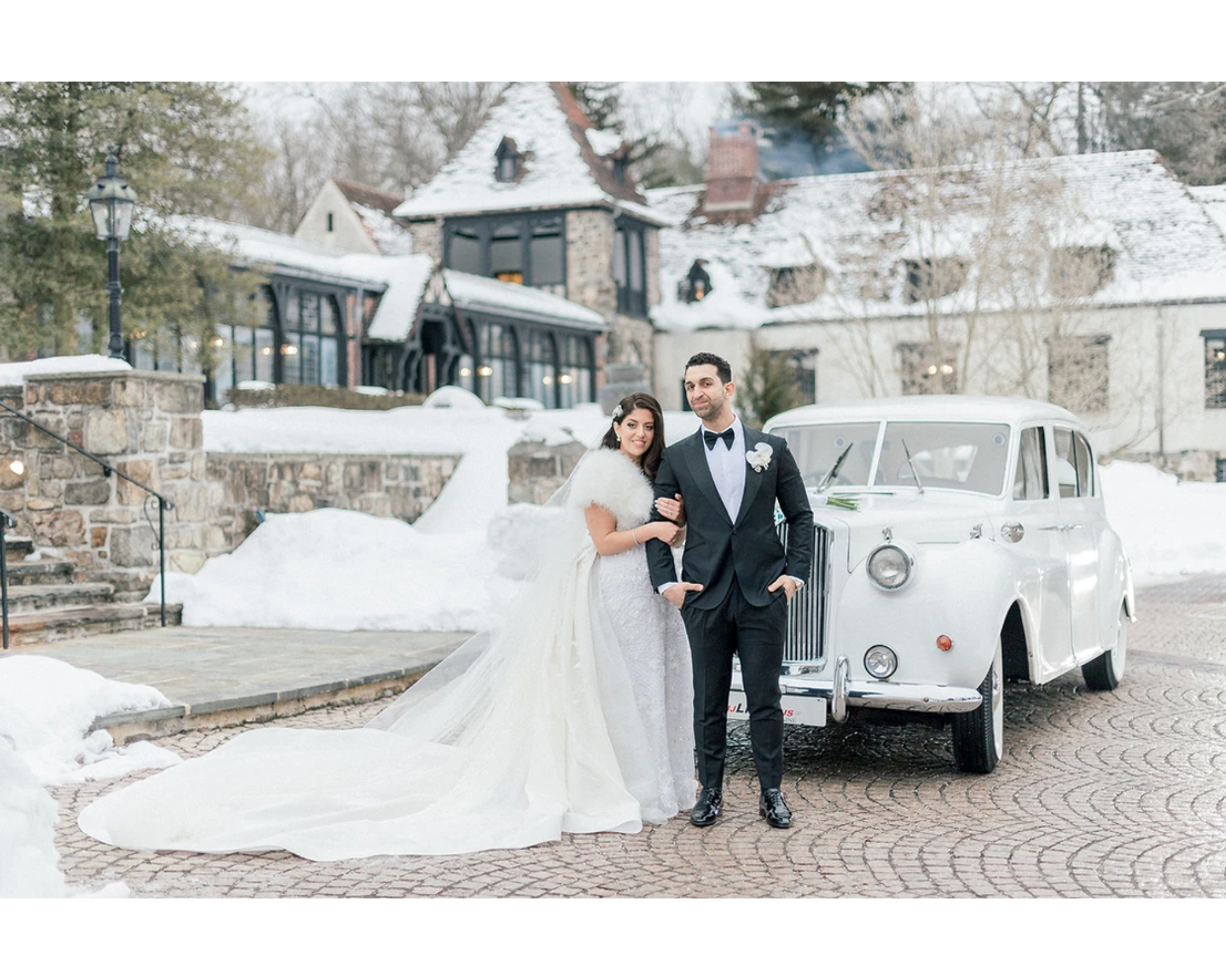 Our beautiful bride Victoria and her groom Teddy standing in front Rolls Royce on their snowy wedding day.