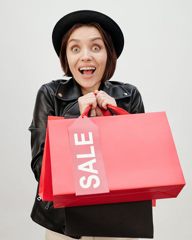 A Happy Woman Holding Shopping Paper Bags