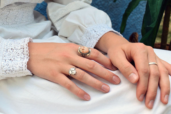 woman wearing white long-sleeved dress wearing fashion rings on both hands