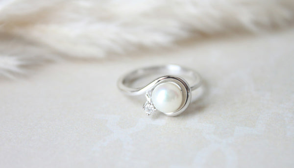 photo of a pearl fashion ring on a white surface