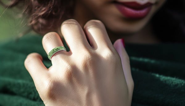 woman wearing infinite sparkle ring in peridot green crystals