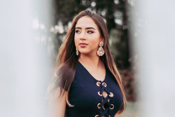 woman with long hair wearing swarovski drop earrings