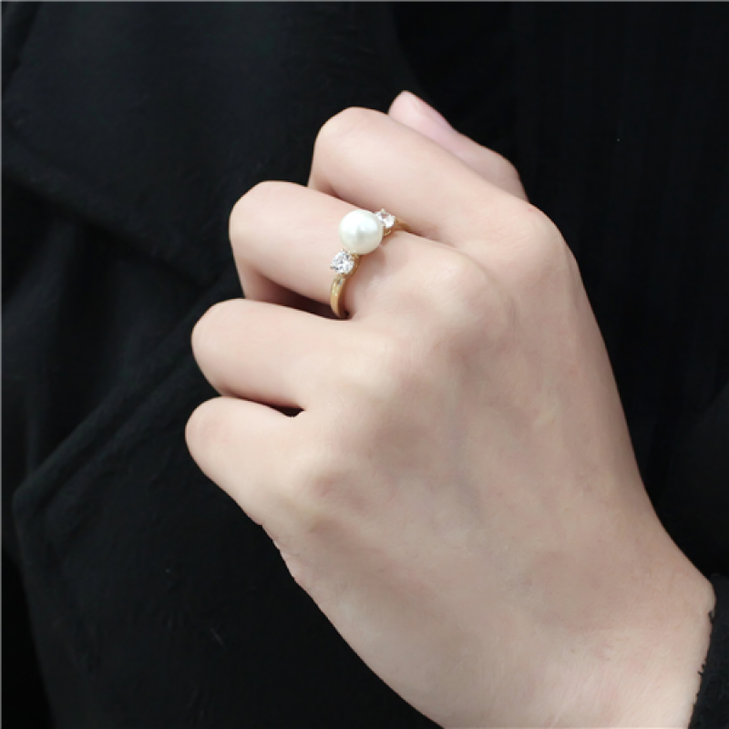 Woman's hand wearing the Stainless Steel IP Gold Synthetic Minimal White Pearl Ring from CeriJewelry