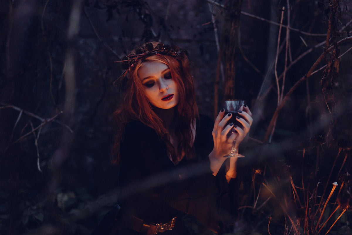 Woman wearing a black costume in the forest