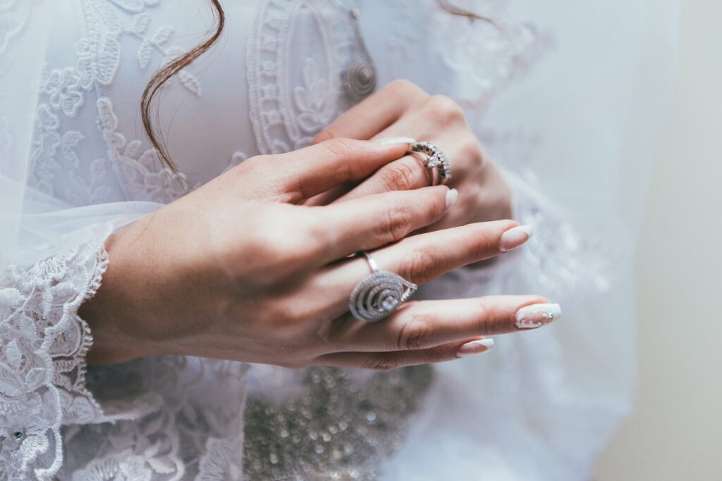 bride holding her wedding rings