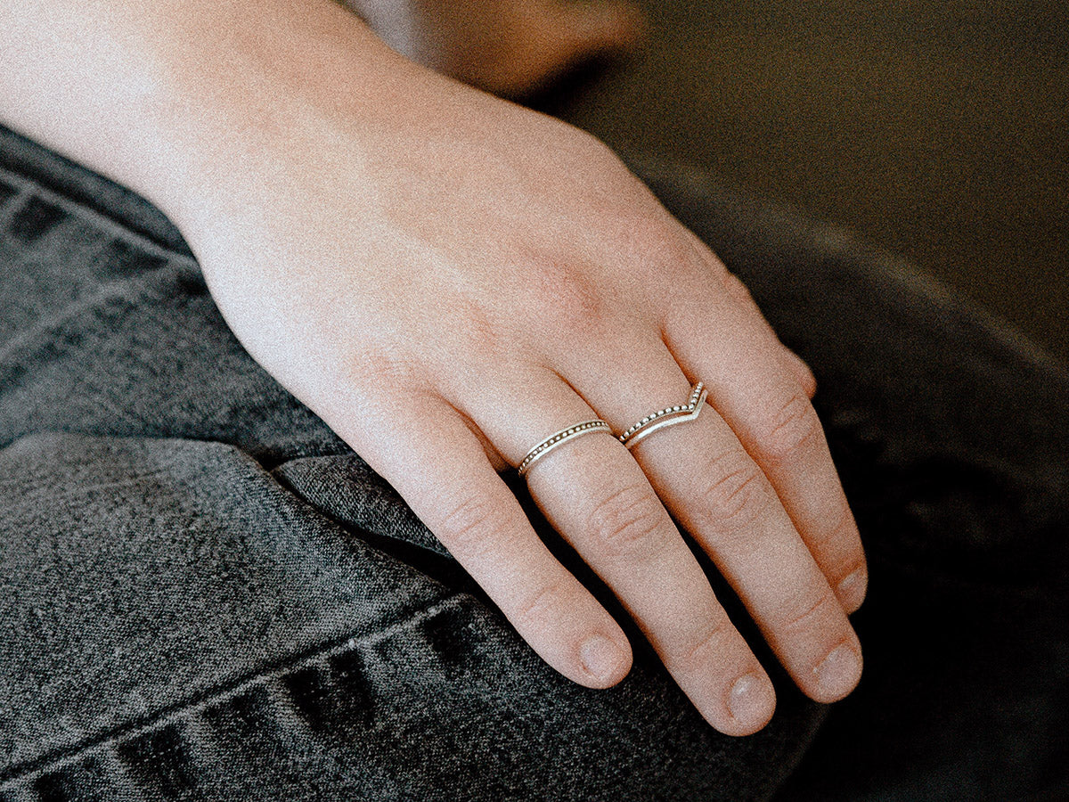 Woman's hand wearing two rings