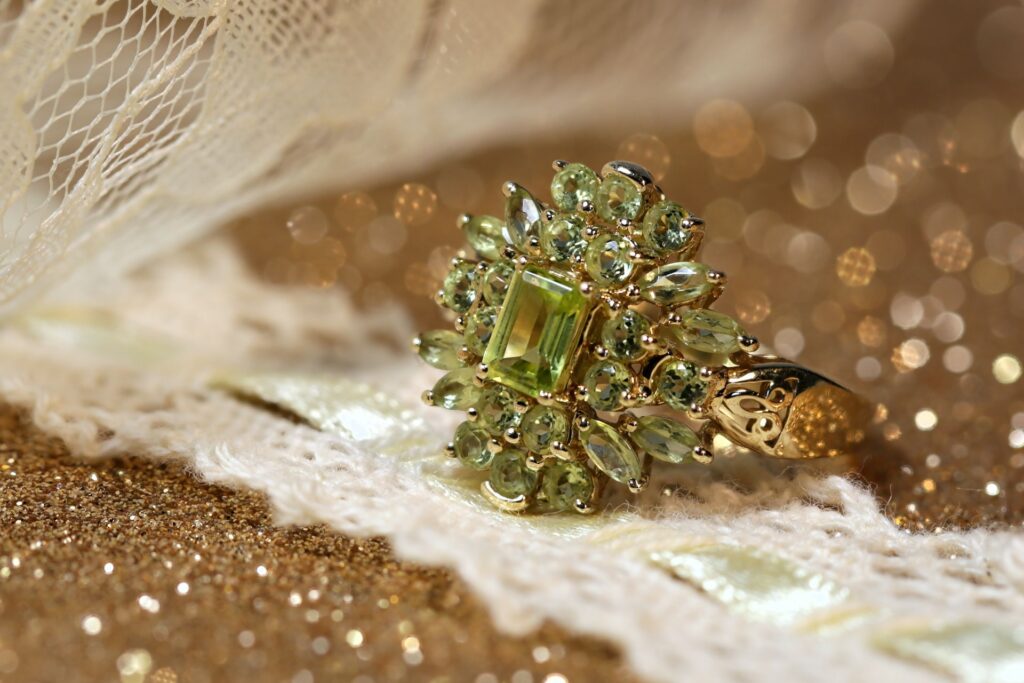 macro photography of a peridot ring with a floral style