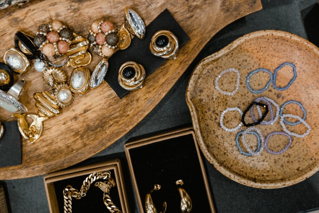 fashion jewelry pieces on display on wooden jewelry display