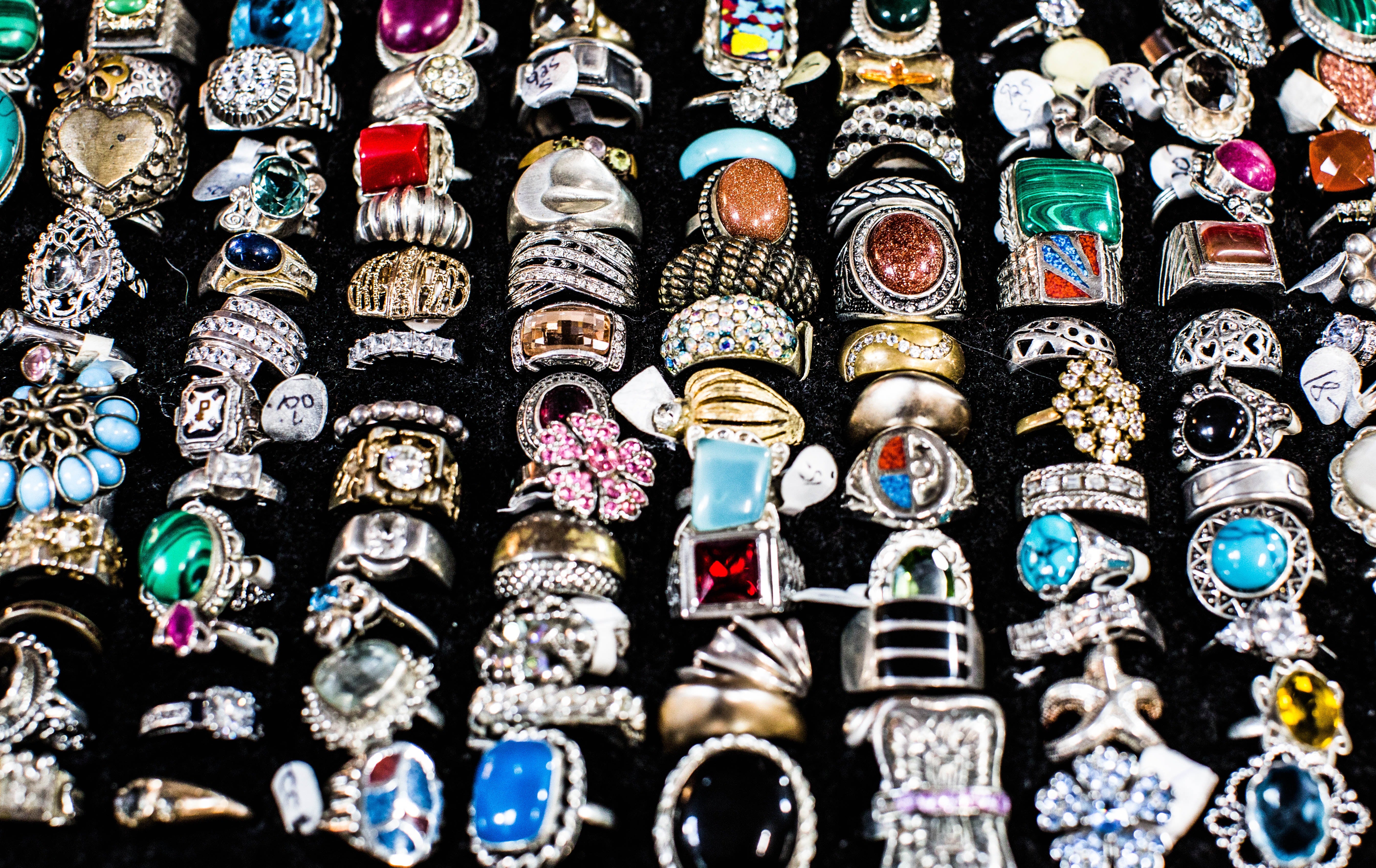 fashion rings of various designs displayed on a black ring tray