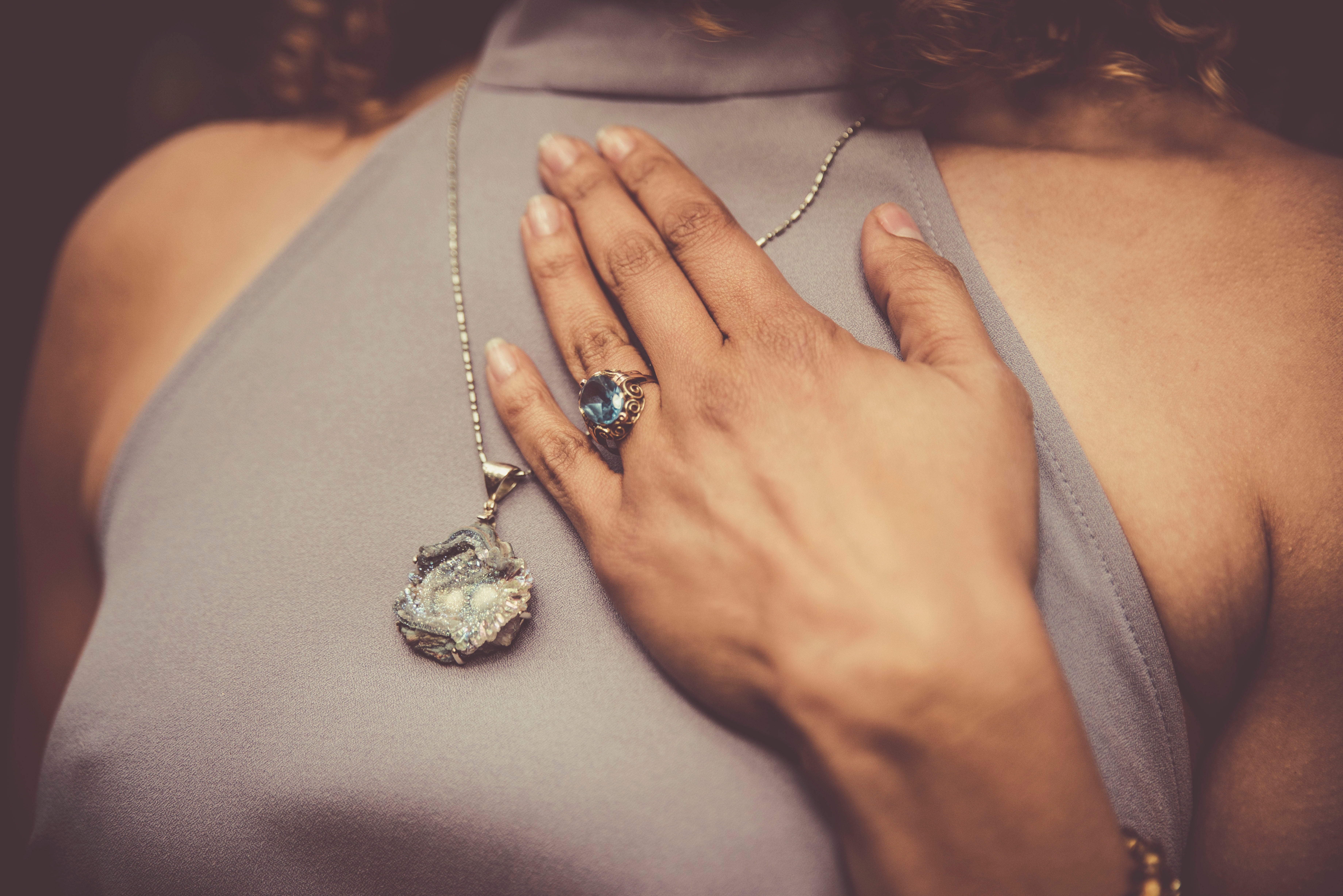 woman wearing swarovski pendant necklace and swarovski ring