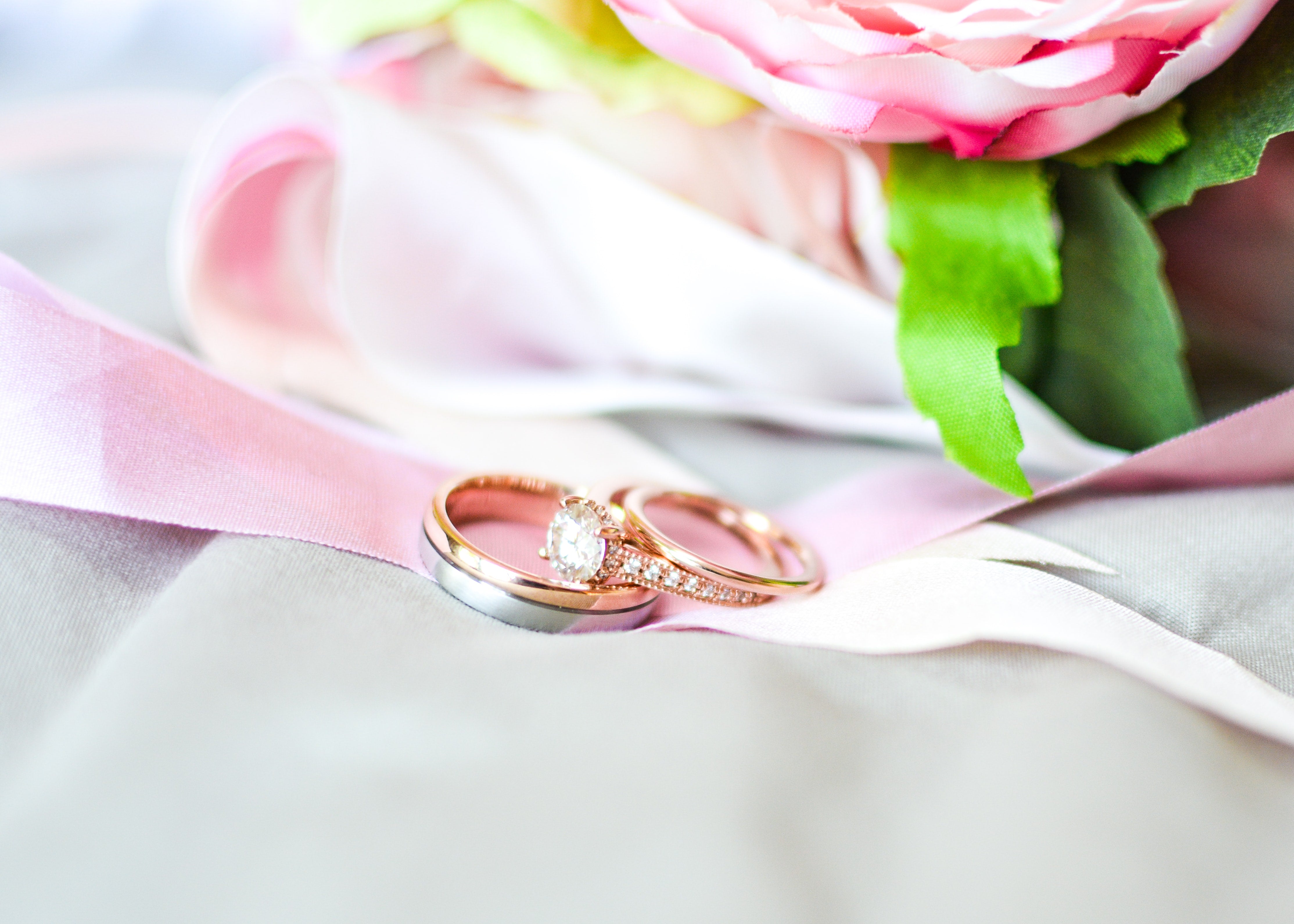 creative photo of rose gold wedding rings of bride and groom