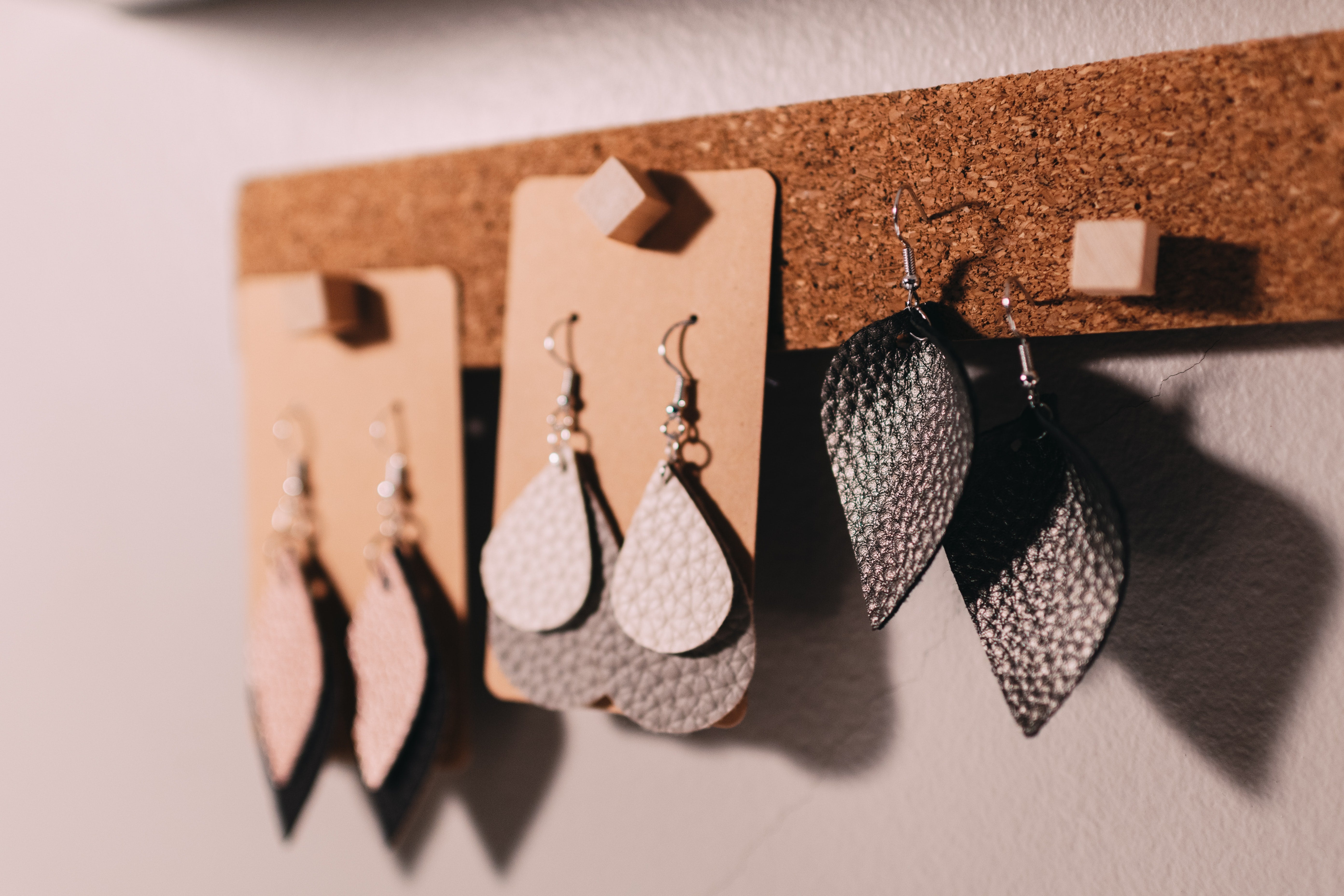 hook earrings hanging on a cork display