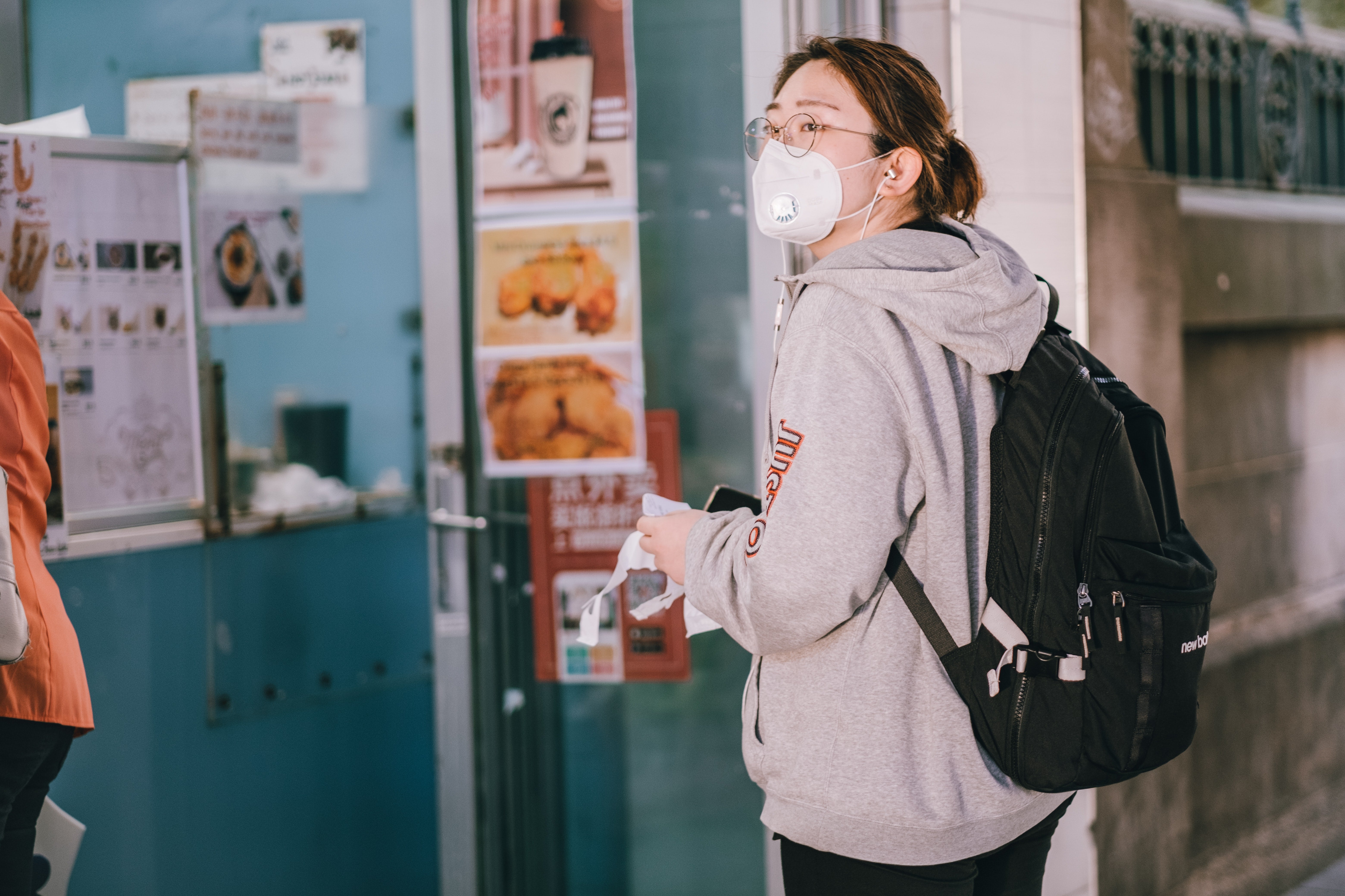 woman with a face mask entering a business establishment