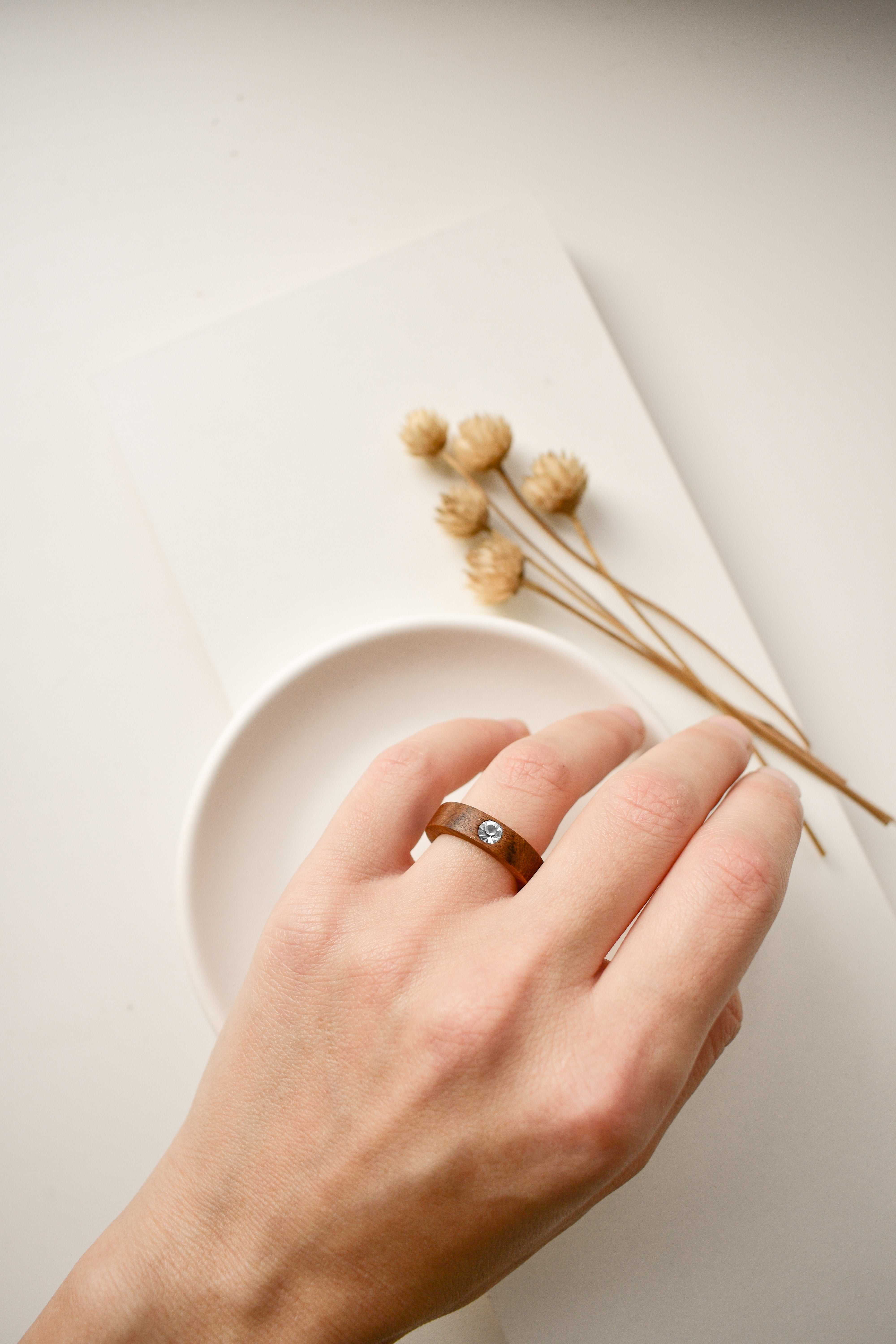 woman's hand wearing chocolate plated fashion ring with clear stone