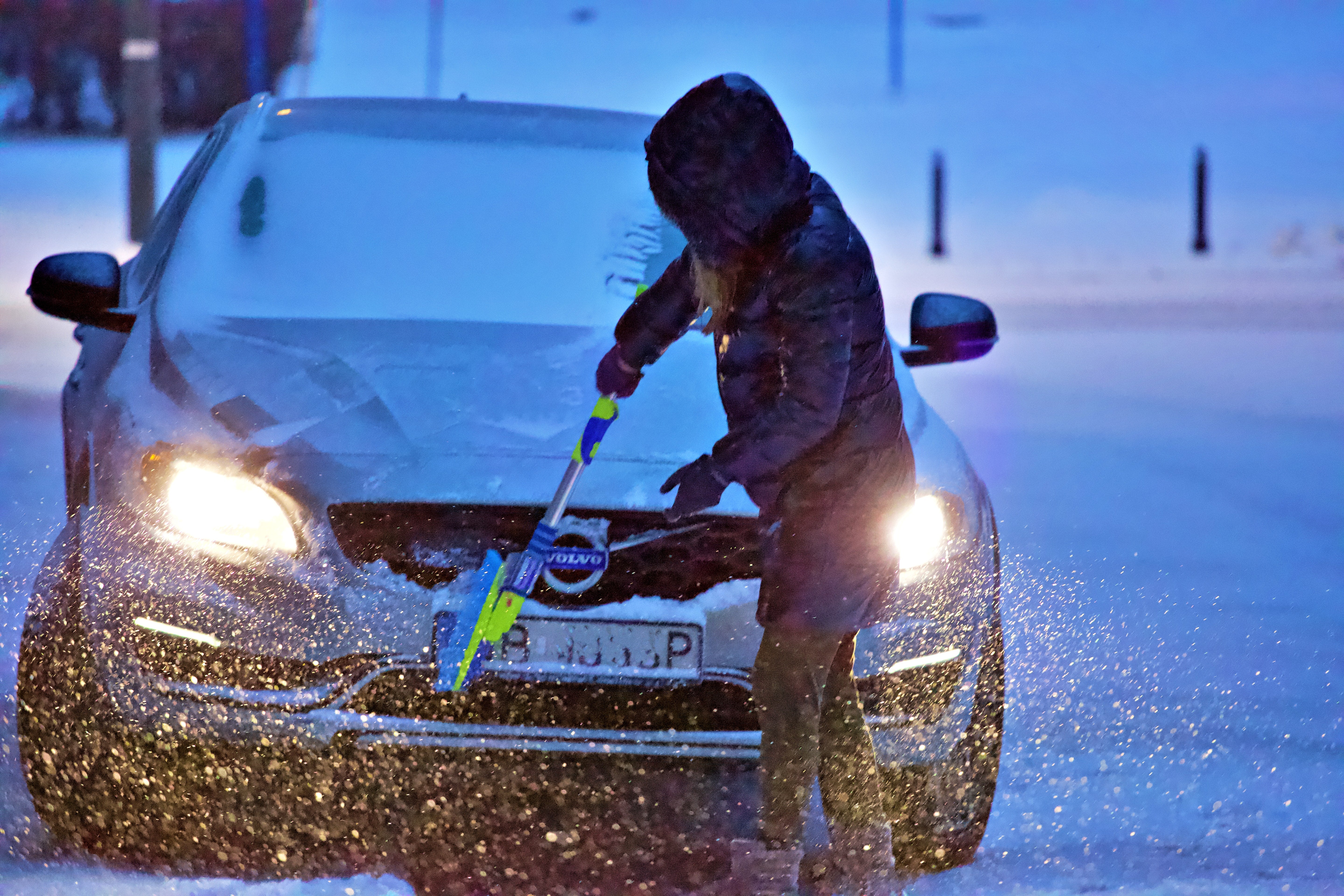 woman in a hoodie doing a carwash