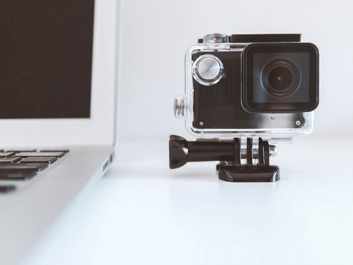 Laptop and GoPro on a white table