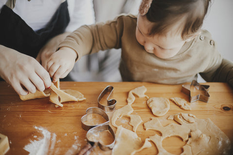 small child makes gingerbread cookies holiday treats for kids