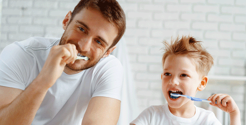 dad and son brushing teeth together blog by 20 Moments of Tooth