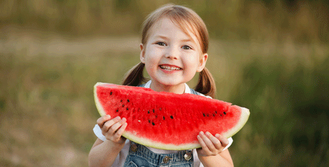 happy child about to start losing her baby teeth blog by 20 Moments of Tooth