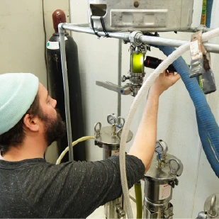 Owner, Patrick Martin, Inspecting our new filtration system, designed in house to preserve polyphenols, aromatic compounds, and health benefits of our cold pressed olive oils.