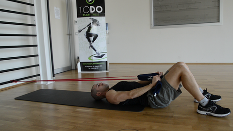 man doing resistance band pull ups