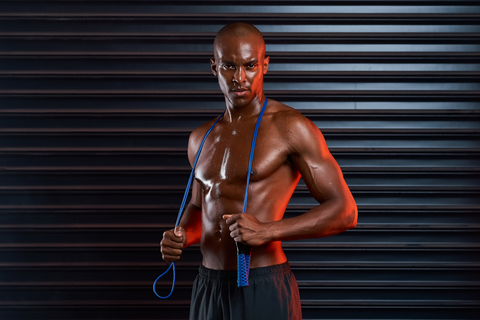 muscular man with resistance band around neck