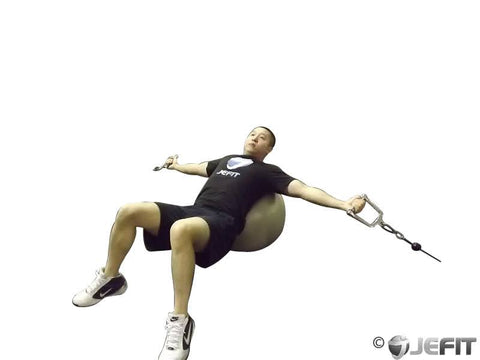 man doing a chest fly on stability ball