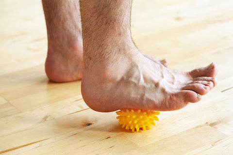 rolling ball of foot on spiky massage ball